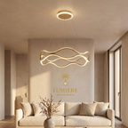 Suspension Wave Gold forme vague dorée LED salon luxe - luminaire organique design Maroc - Lumière des Palmiers
